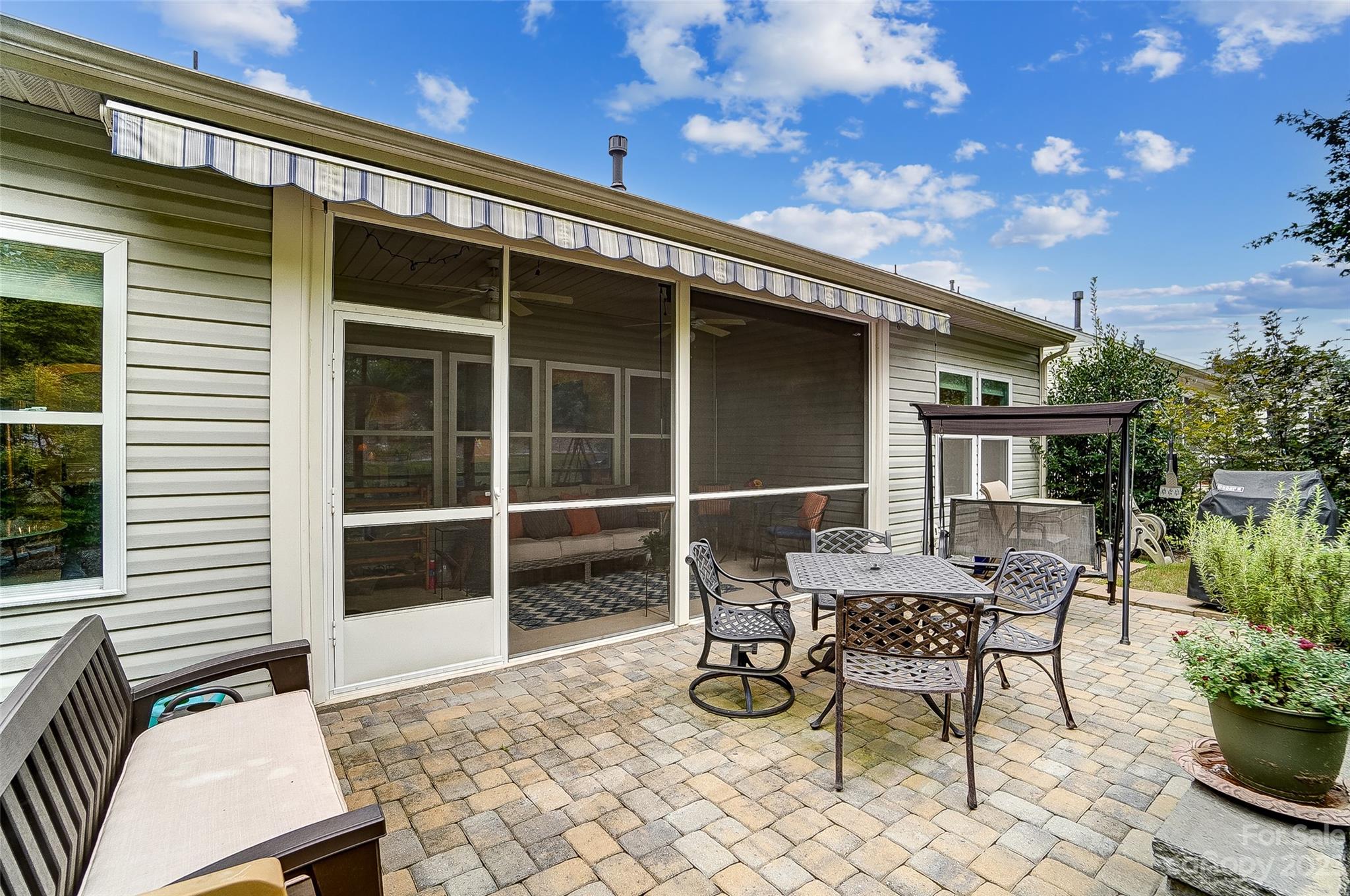 1862 Larkspur Way Tega Cay, SC 29708 - Photo 34 of 37 a patio with table and chairs and potted plants