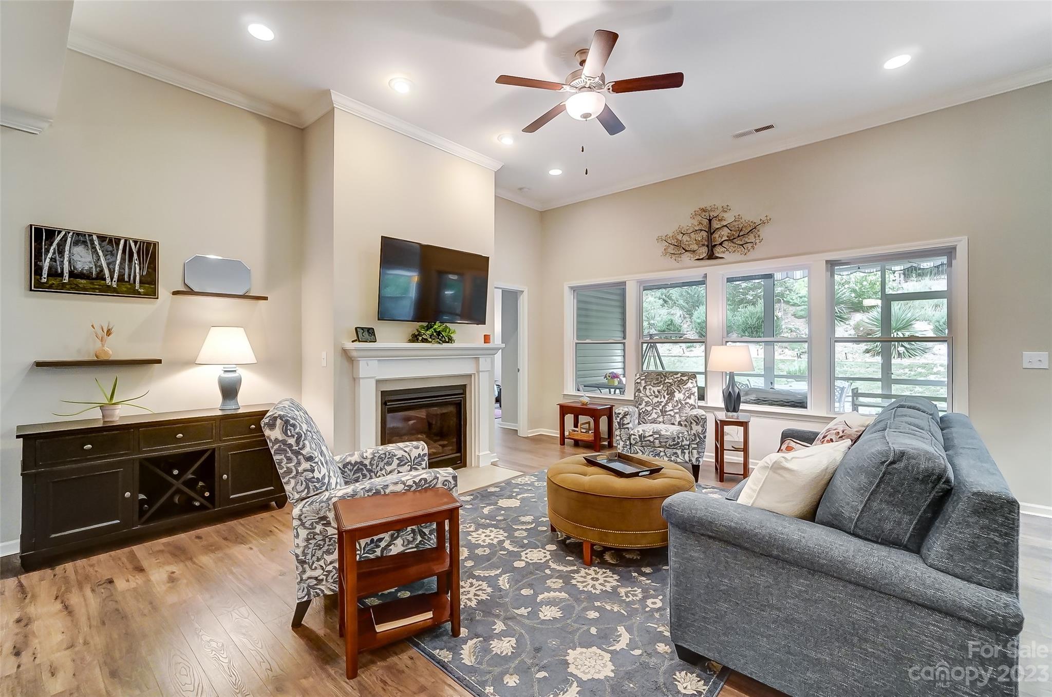 1862 Larkspur Way Tega Cay, SC 29708 - Photo 5 of 37 a living room with furniture a fireplace and a flat screen tv