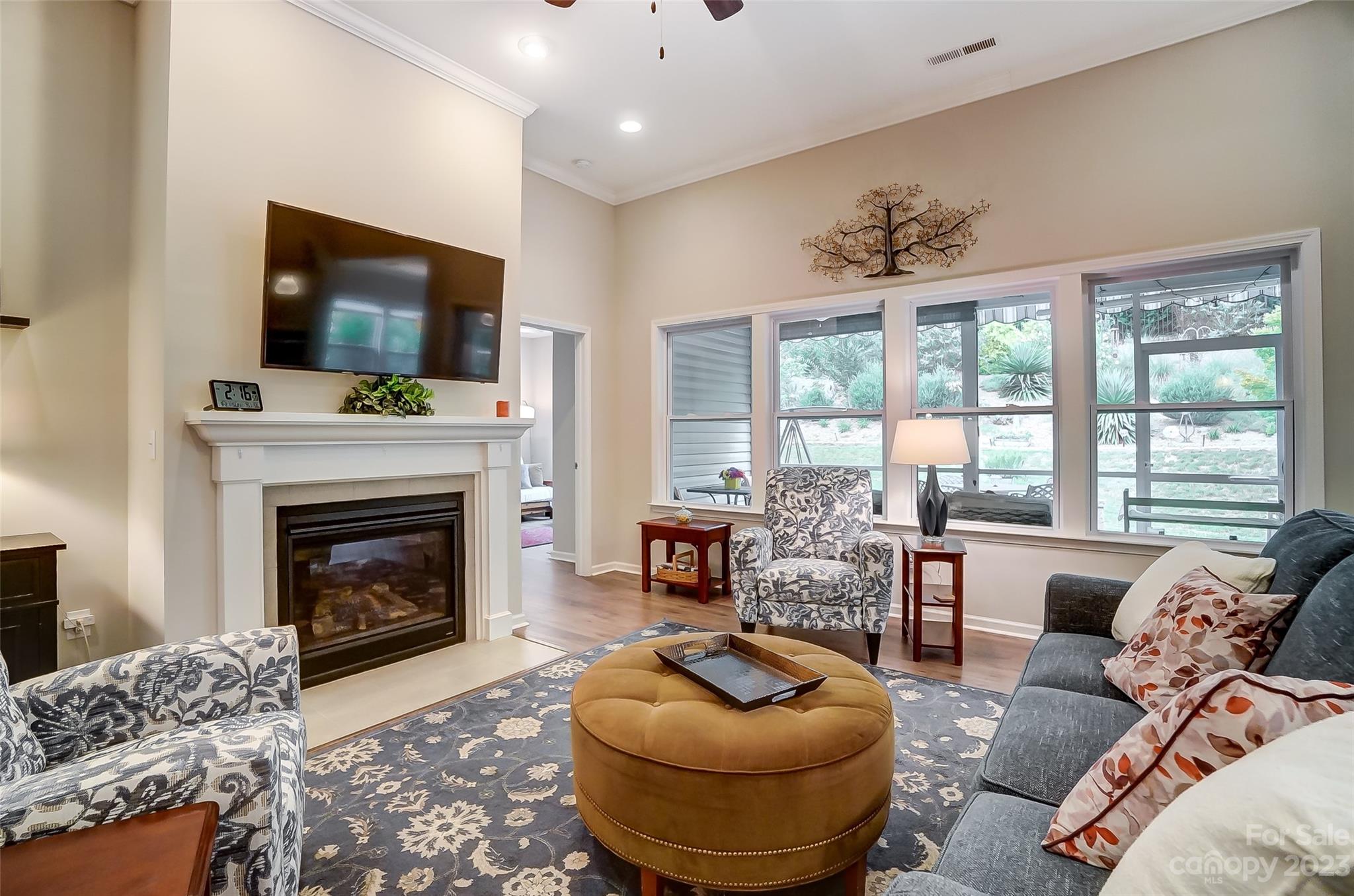 1862 Larkspur Way Tega Cay, SC 29708 - Photo 6 of 37 a living room with furniture a flat screen tv and a fireplace