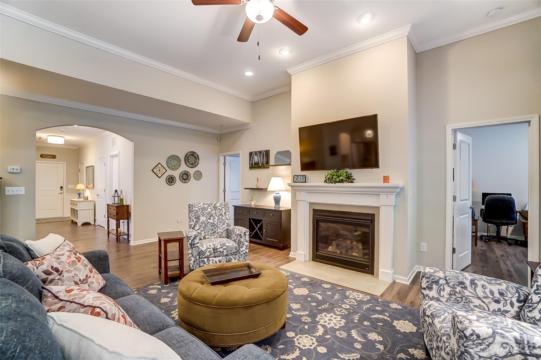 1862 Larkspur Way Tega Cay, SC 29708 - Photo 7 of 37 a living room with furniture a flat screen tv and a fireplace