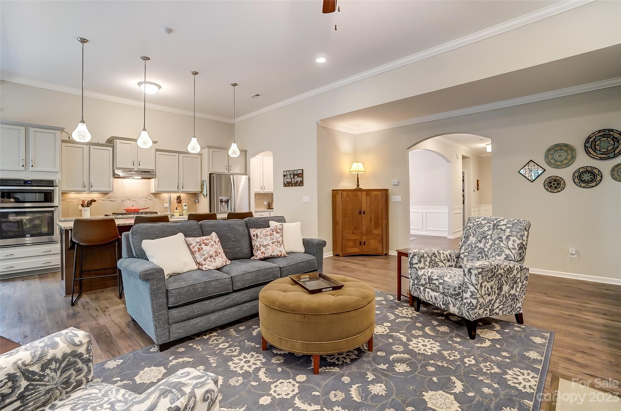 1862 Larkspur Way Tega Cay, SC 29708 - Photo 9 of 37 a living room with furniture and a chandelier