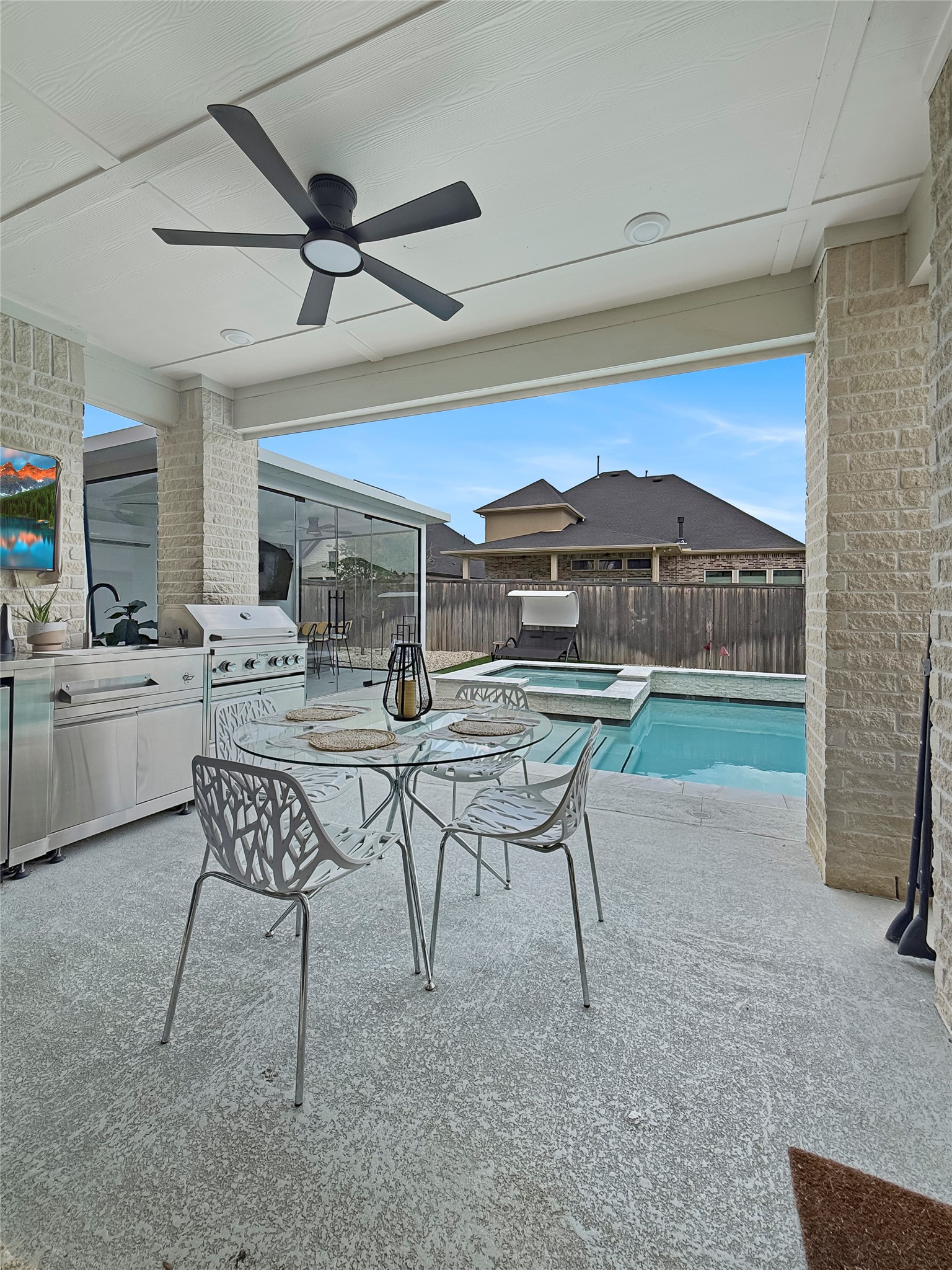 26918 Swanborough Road Spring, TX 77389 - Photo 32 of 50 Step outside to a true outdoor living oasis — a spacious covered patio, and a private pool and spa create the ultimate Texas backyard retreat.