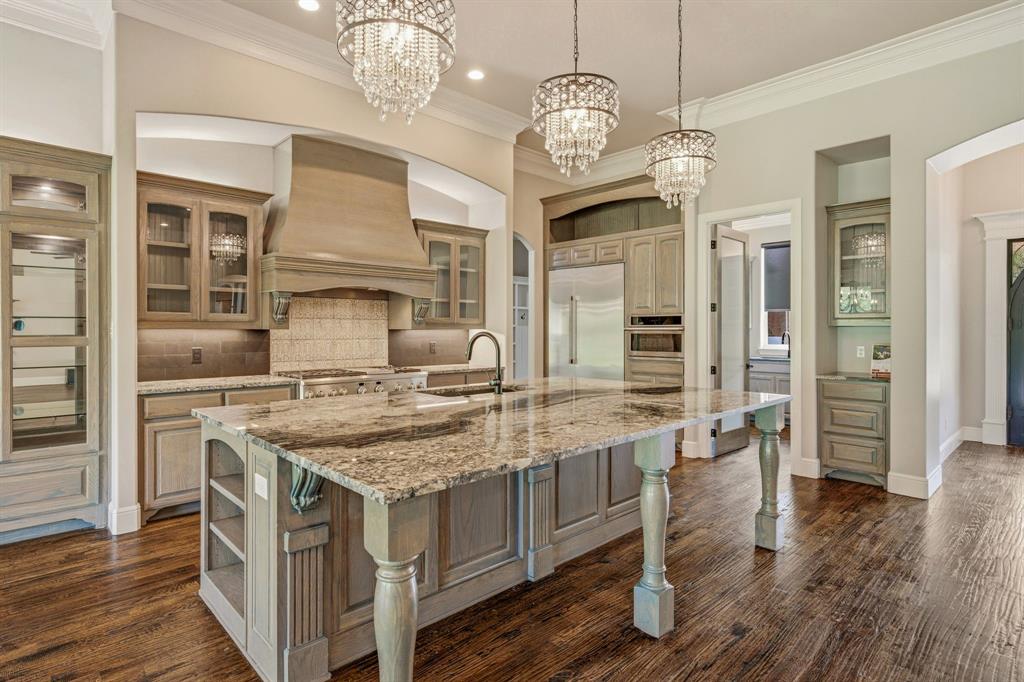 9503 Bellechase Road Granbury, TX 76049 - Photo 9 of 40 a kitchen with stainless steel appliances granite countertop a stove and cabinets