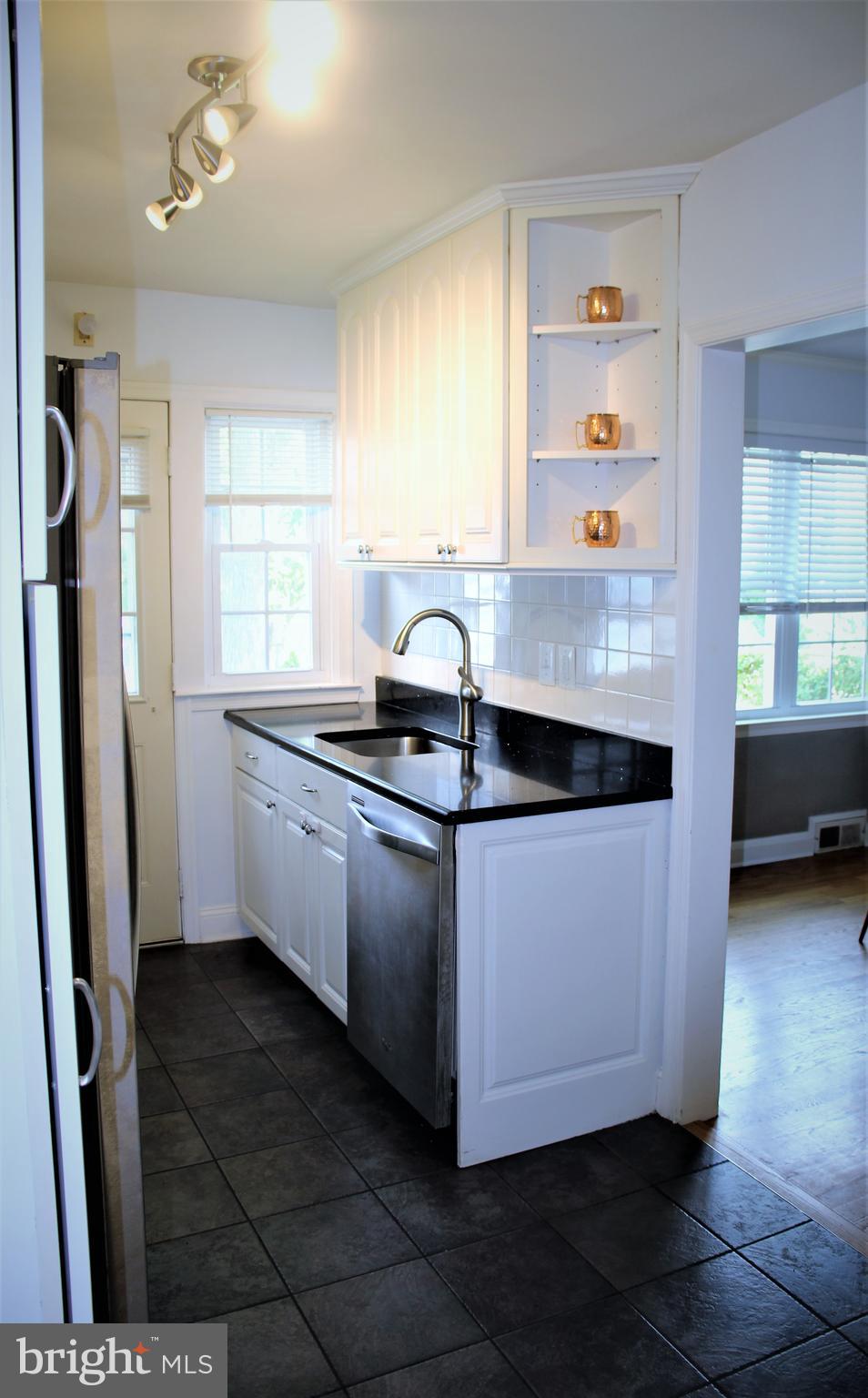 1746 Glen Ridge Road Towson, MD 21286 - Photo 12 of 48 a kitchen with stainless steel appliances a sink a stove a refrigerator a window and a counter top space