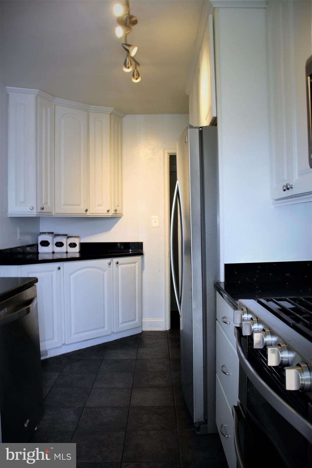 1746 Glen Ridge Road Towson, MD 21286 - Photo 13 of 48 a kitchen with stainless steel appliances a refrigerator sink and cabinets