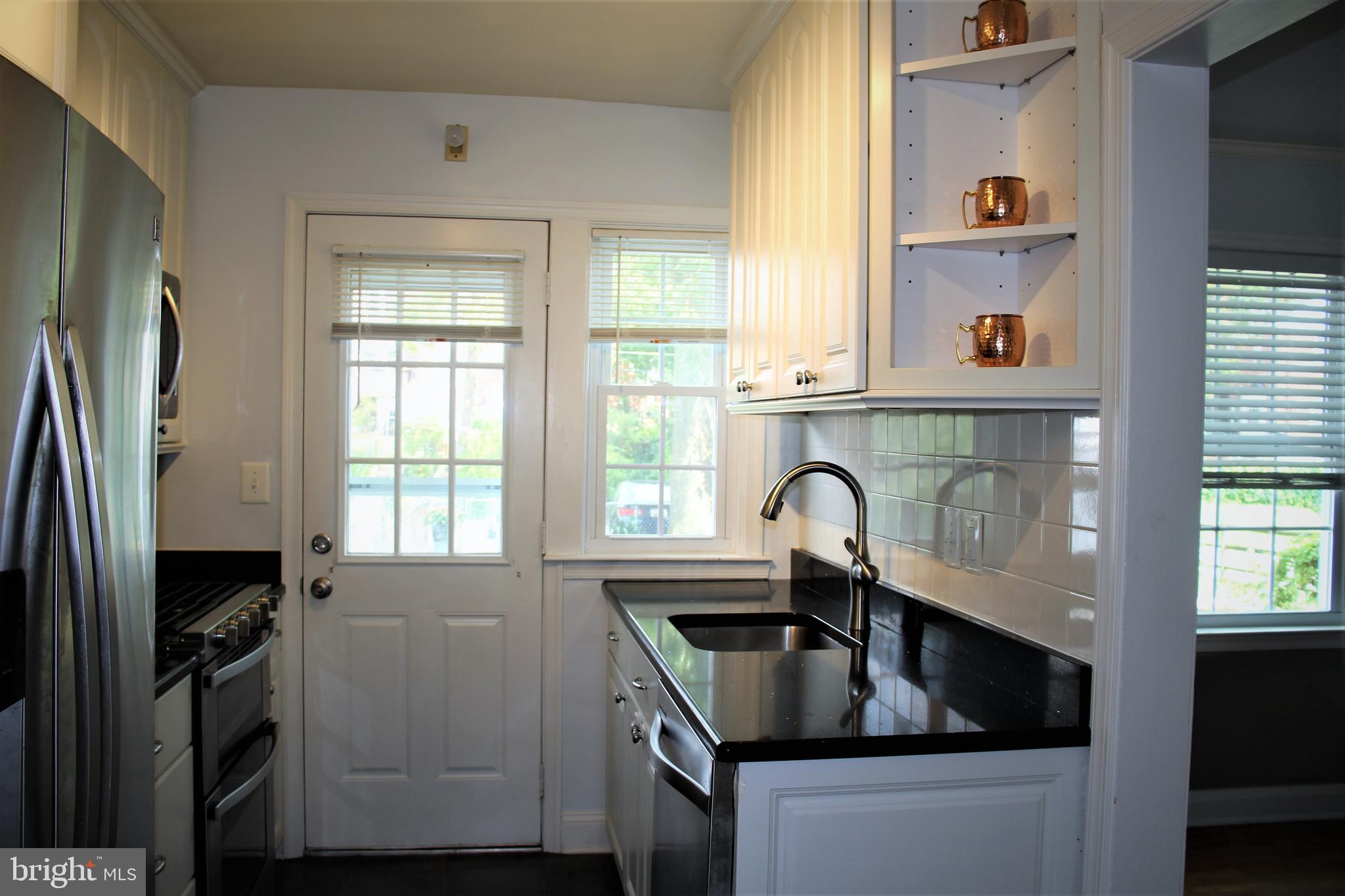 1746 Glen Ridge Road Towson, MD 21286 - Photo 14 of 48 a kitchen with granite countertop a sink stove and refrigerator