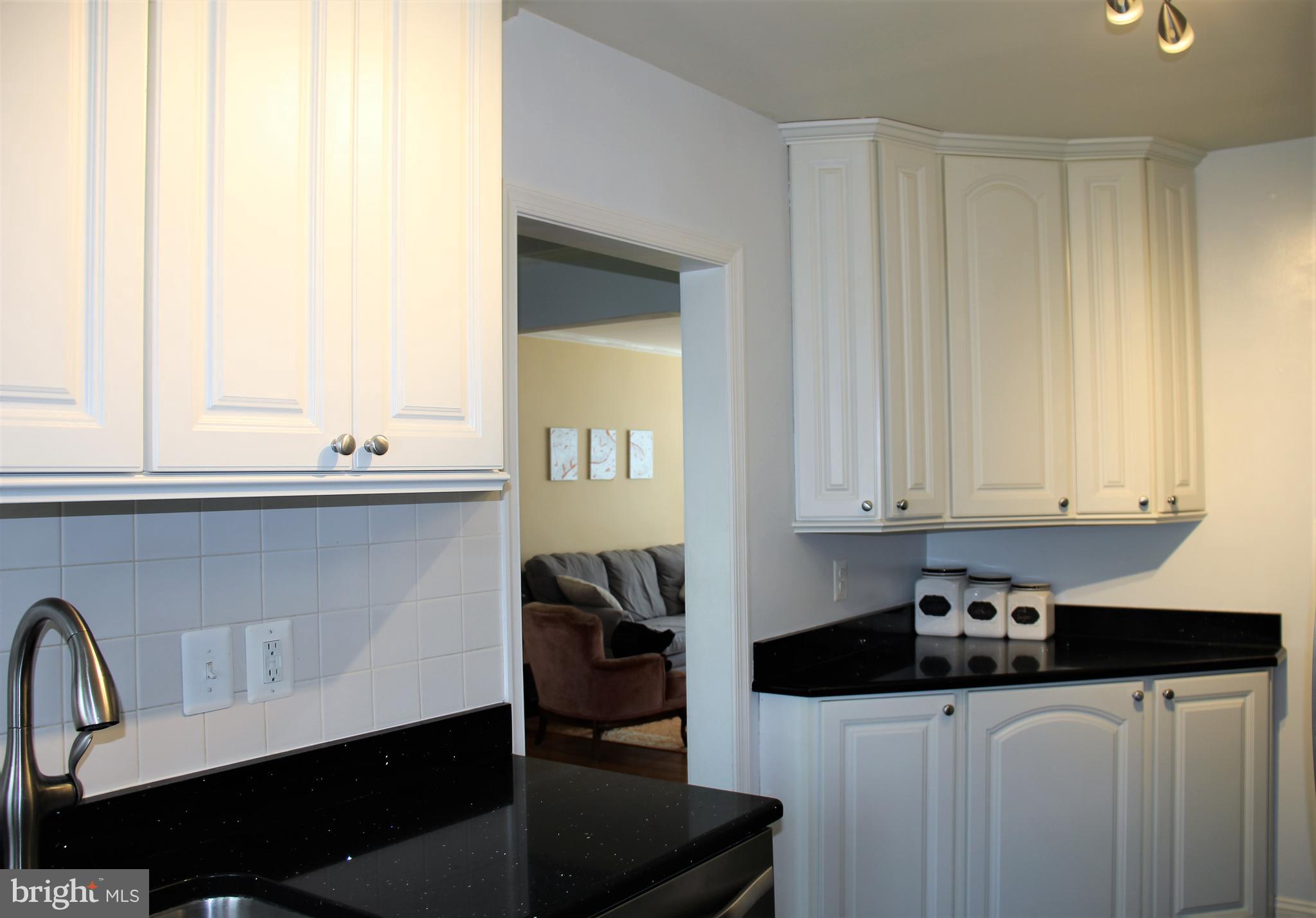 1746 Glen Ridge Road Towson, MD 21286 - Photo 15 of 48 a kitchen with stainless steel appliances a sink a stove and white cabinets