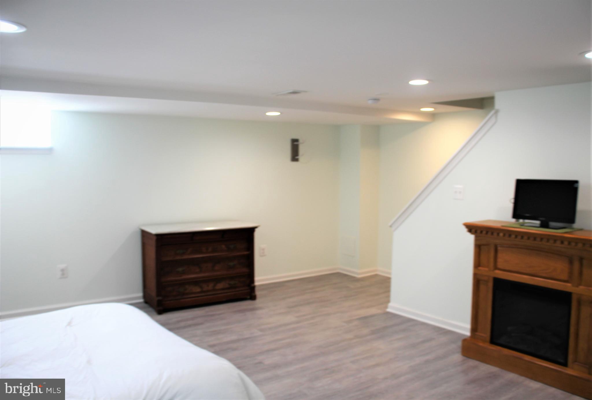 1746 Glen Ridge Road Towson, MD 21286 - Photo 37 of 48 a bedroom with furniture and a fireplace