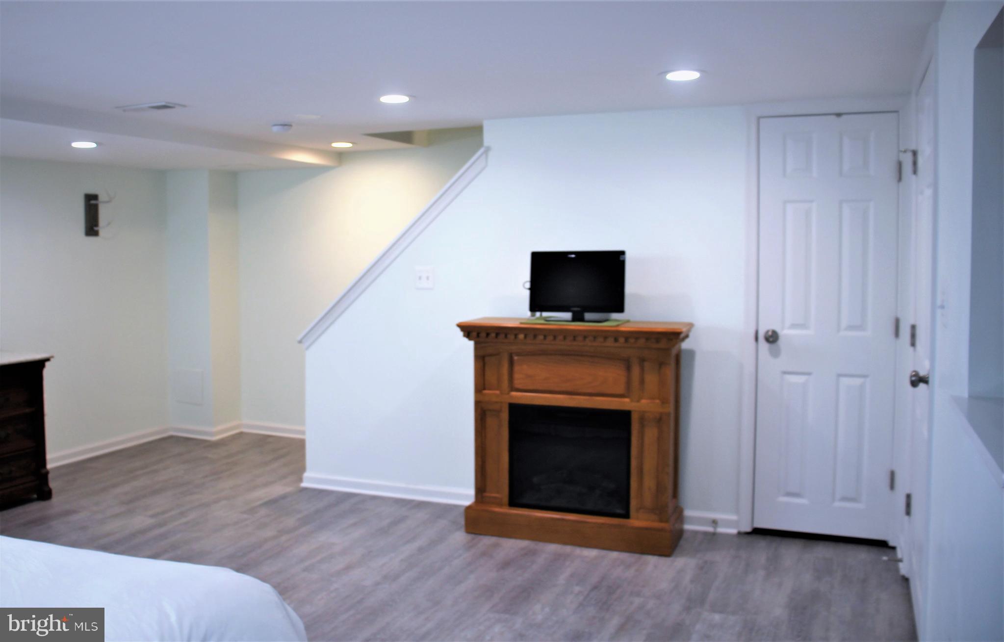 1746 Glen Ridge Road Towson, MD 21286 - Photo 38 of 48 a view of an empty room with wooden floor and a fireplace