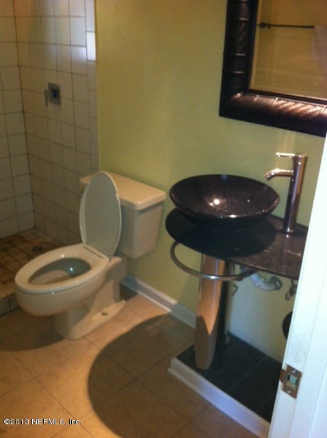 7253 Sandhurst Road South Jacksonville, FL 32277 - Photo 11 of 13 a bathroom with a toilet and a mirror