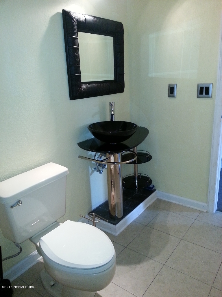 7253 Sandhurst Road South Jacksonville, FL 32277 - Photo 13 of 13 a bathroom with a toilet a sink and mirror