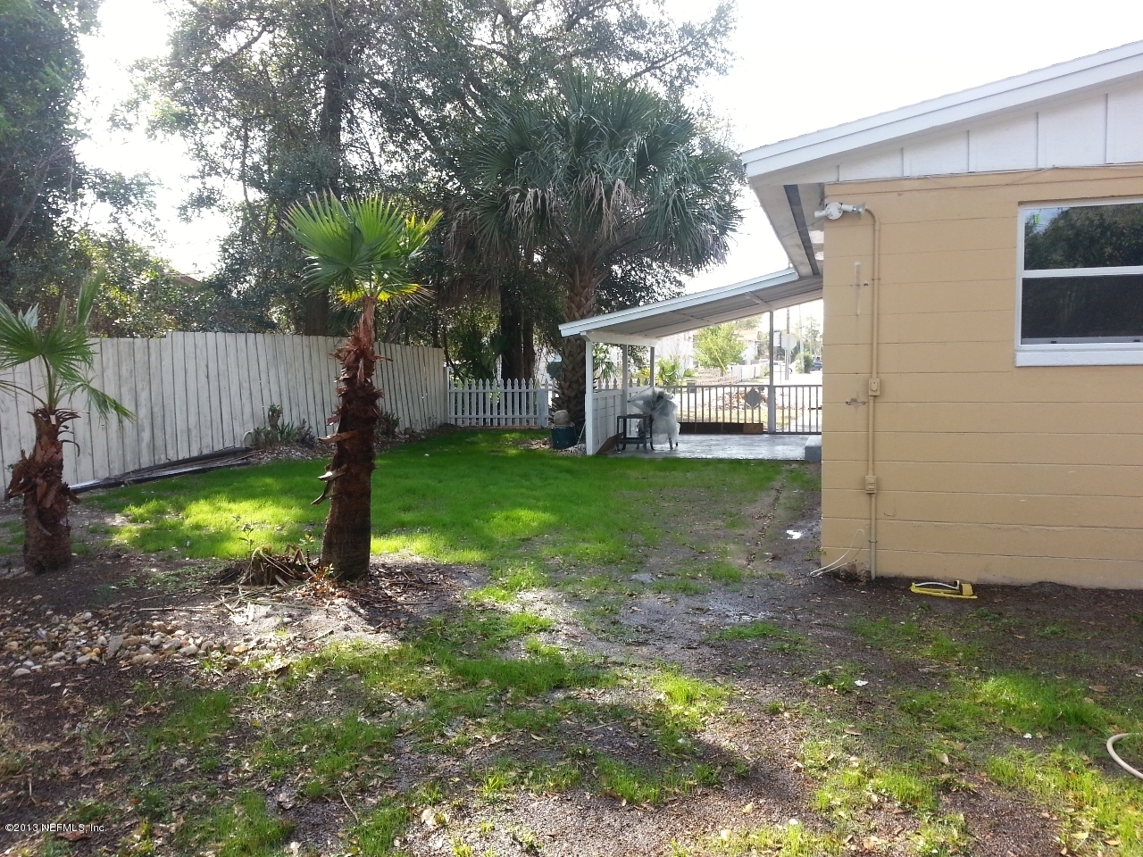 7253 Sandhurst Road South Jacksonville, FL 32277 - Photo 8 of 13 a view of a backyard with a house and a large tree
