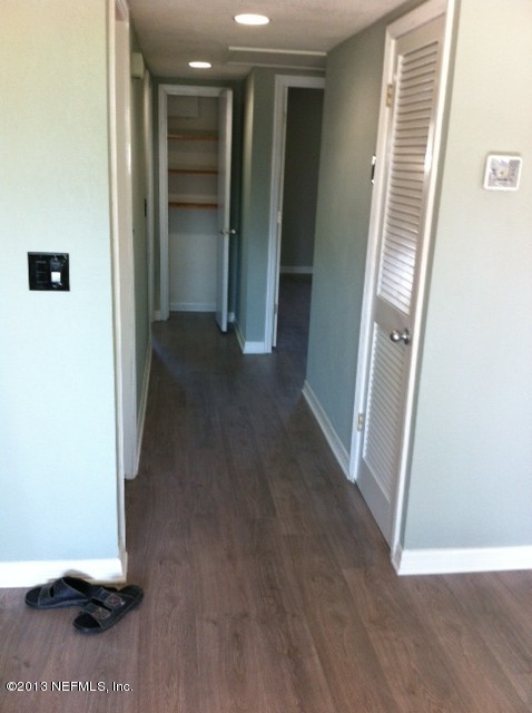 7253 Sandhurst Road South Jacksonville, FL 32277 - Photo 10 of 13 a view of a hallway with wooden shelves