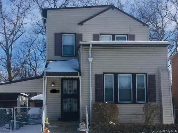 a front view of a house with parking space