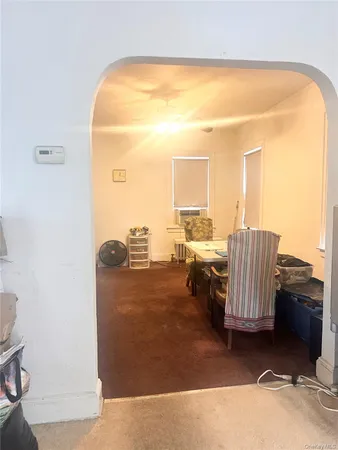 a view of a living room with furniture and a floor to ceiling window