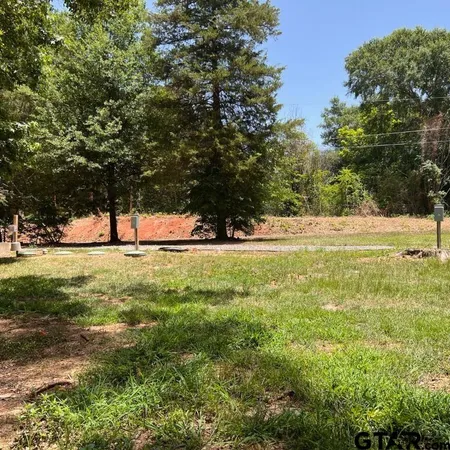 a view of outdoor space with garden and trees