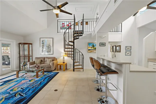 a living room with furniture and a dining table