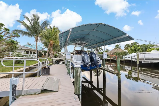 a view of a swimming pool with a patio and a yard