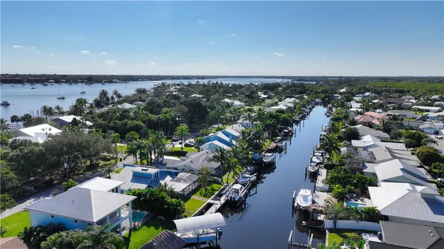 an aerial view of a house with a yard and lake view