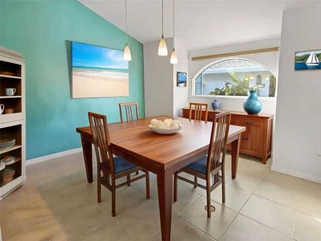 a view of a dining room with furniture and a potted plant