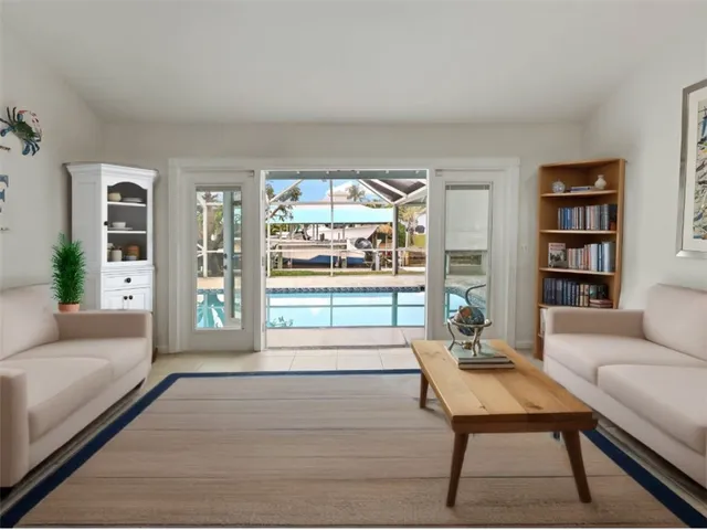 a living room with furniture a rug and a table