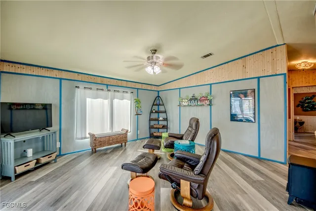 a living room with furniture gym equipment and a large window