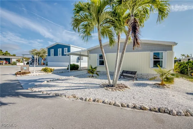 a view of a house with a yard and sitting area