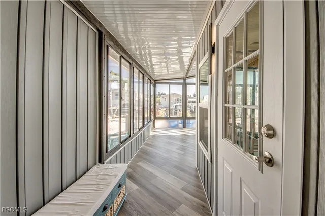 a view of a dining room with furniture large windows and wooden floor