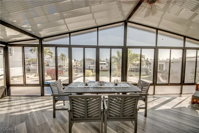 a dining room with furniture window and wooden floor