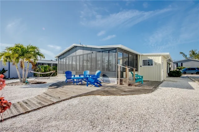 a view of an ocean with boats and trees in the background