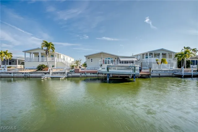 a sign board with buildings in the background