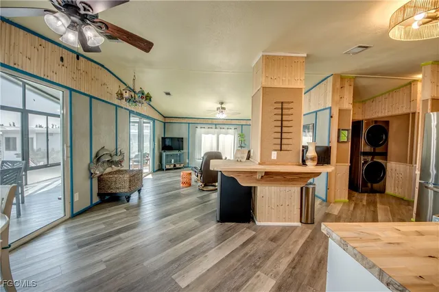a large kitchen with stainless steel appliances granite countertop a lot of counter space and a wooden floor