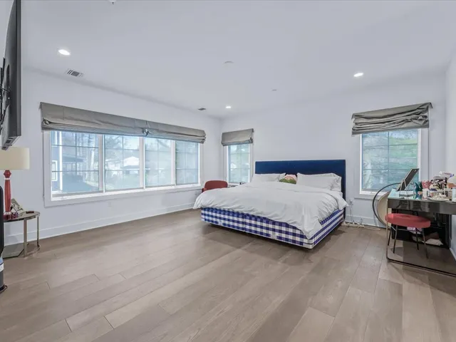 a spacious bedroom with a bed and window