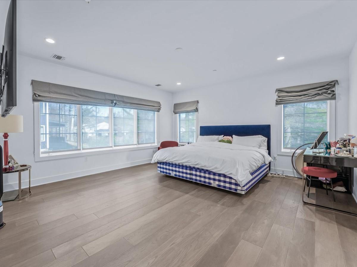 1 Sequoia Circle Manhasset, NY 11030 - Photo 13 of 24 a spacious bedroom with a bed and window