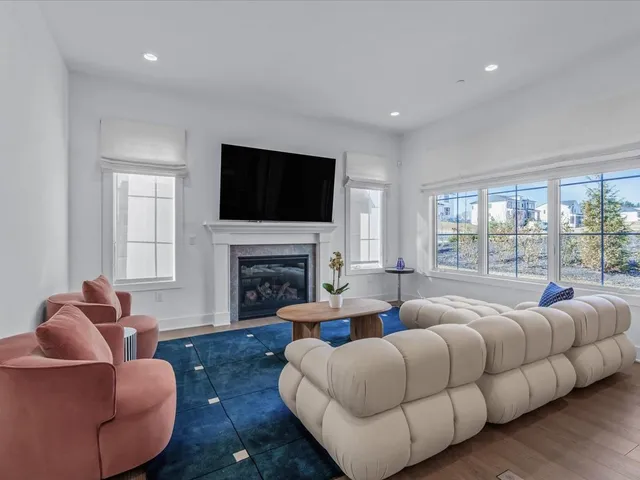 a living room with furniture fireplace and flat screen tv