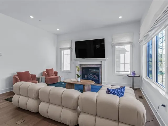 a living room with furniture fireplace and flat screen tv