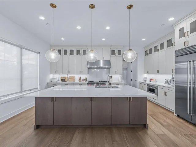 a large kitchen with stainless steel appliances kitchen island a large island in the center