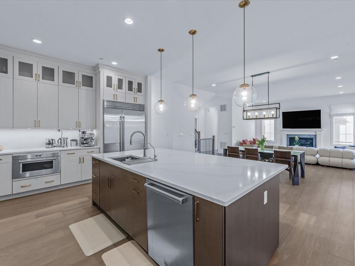 1 Sequoia Circle Manhasset, NY 11030 - Photo 9 of 24 a open kitchen with stainless steel appliances kitchen island a white cabinets and couches