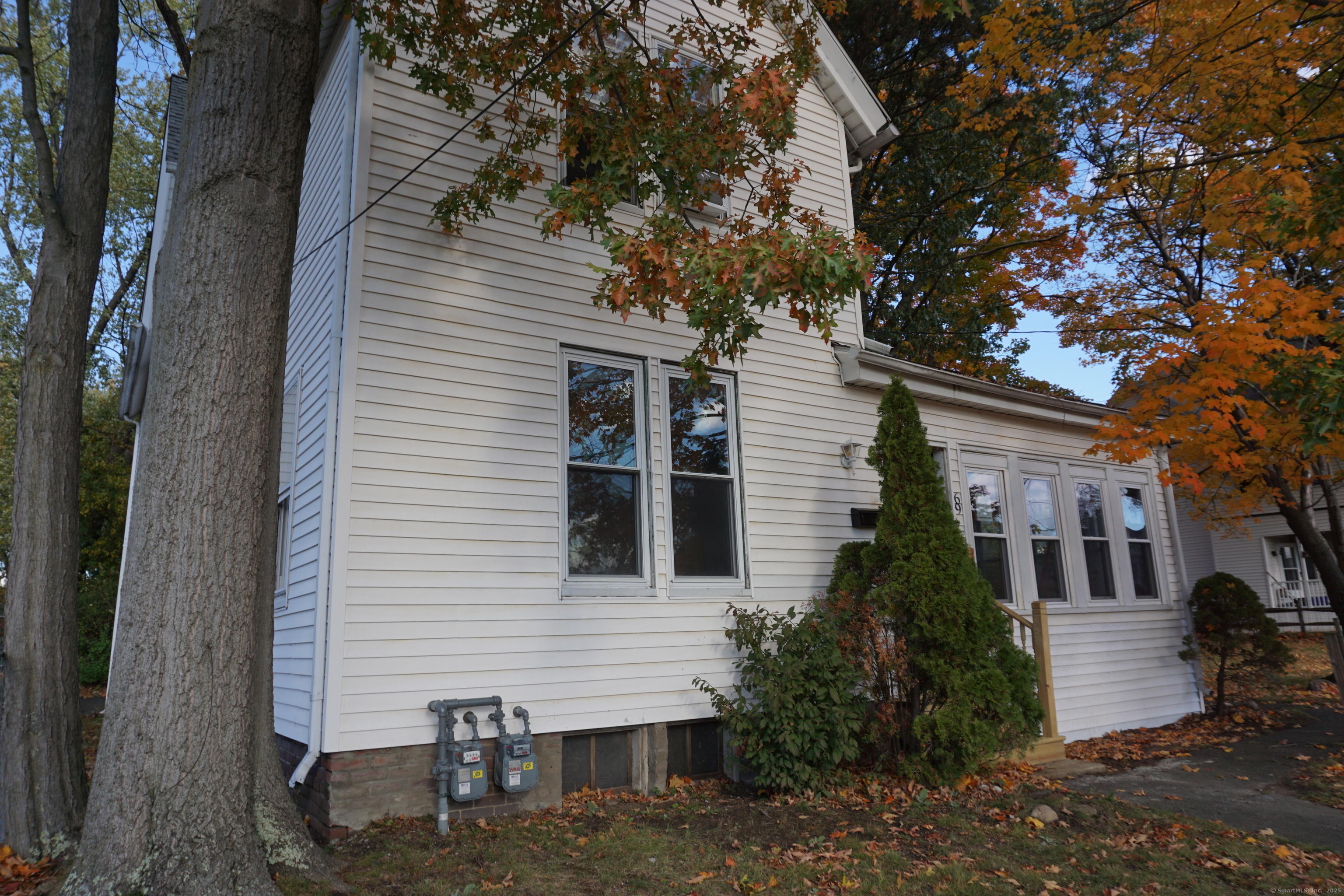 69 Gates Street Holyoke, MA 01040 - Photo 2 of 13 a view of a white house next to a yard with a tree