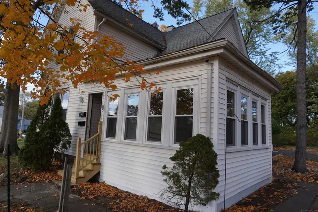front view of a house with a tree