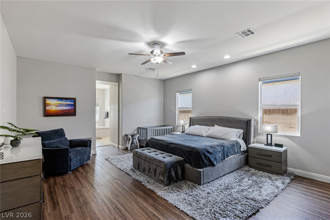 7036 Arabian Ridge Street Las Vegas, NV 89131 - Photo 27 of 64 The spacious primary suite offers a true retreat with automated shades, a spa-inspired ensuite featuring a separate soaking tub, walk-in shower, and an oversized walk-in closet (11'6 x 12'8)