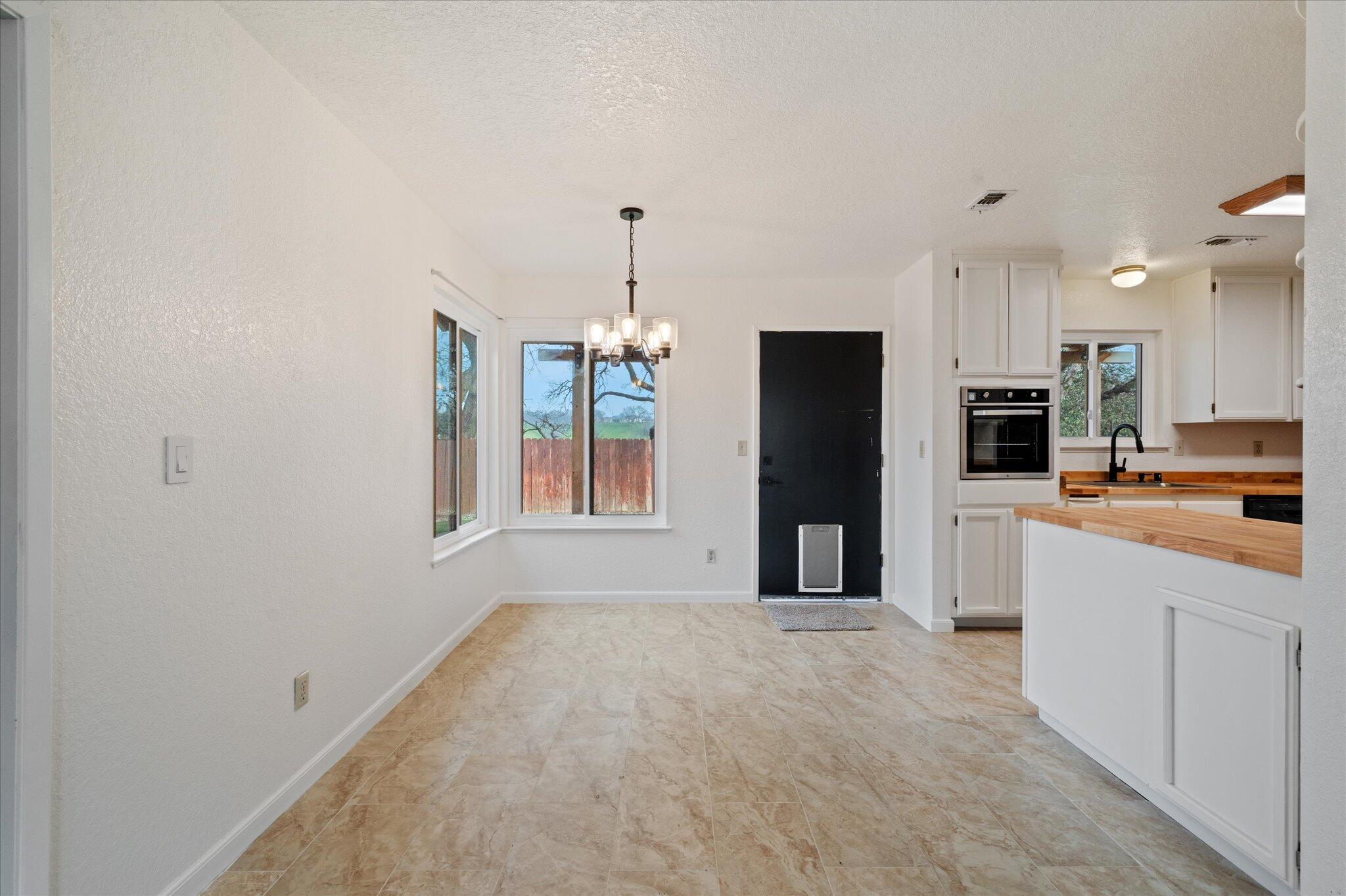 13770 Lisa Way Red Bluff, CA 96080 - Photo 13 of 43 a large kitchen with cabinets and stainless steel appliances