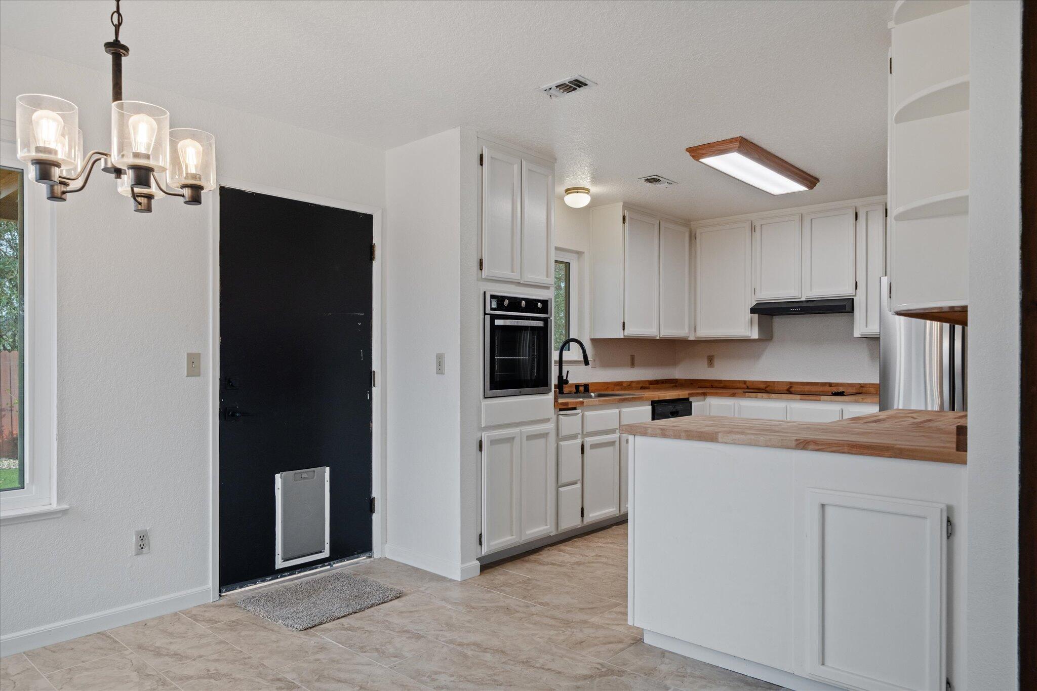 13770 Lisa Way Red Bluff, CA 96080 - Photo 14 of 43 a kitchen with kitchen island granite countertop appliances cabinets and a counter top space