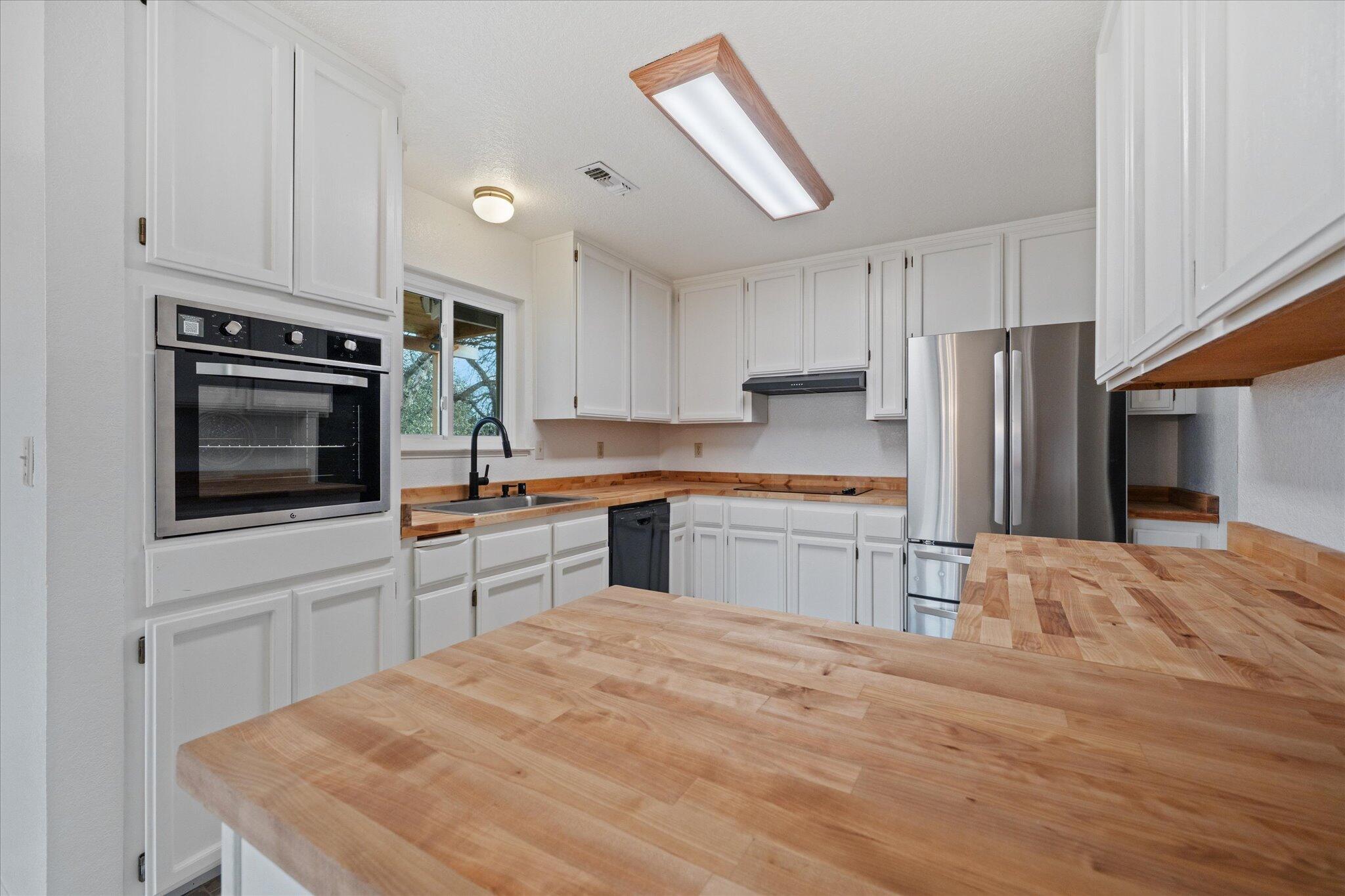 13770 Lisa Way Red Bluff, CA 96080 - Photo 16 of 43 a kitchen with granite countertop a refrigerator stove top oven and sink