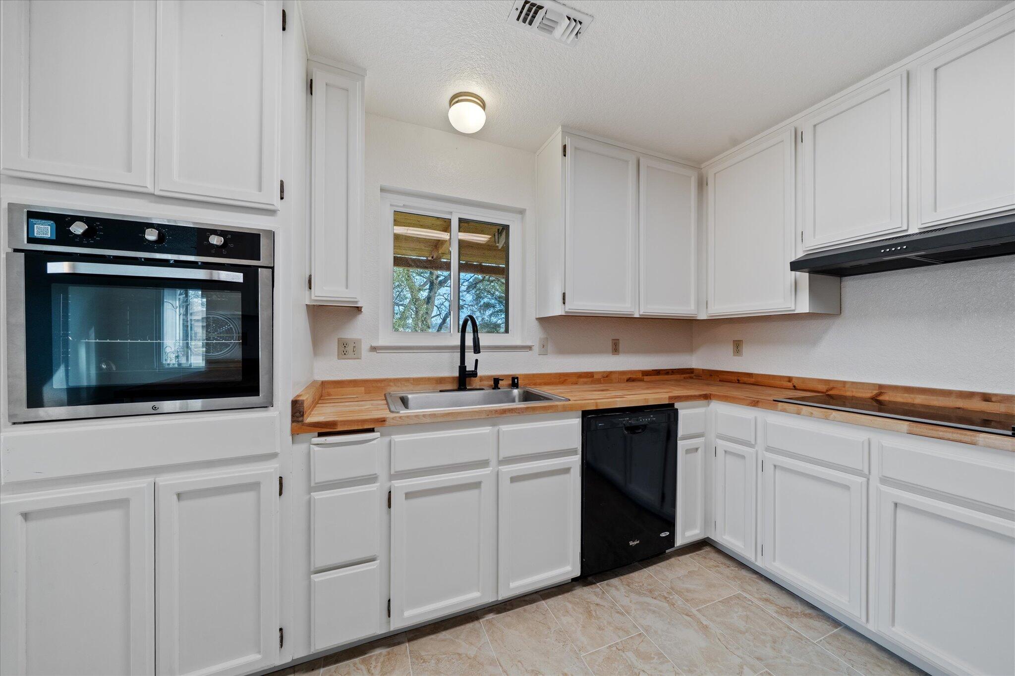13770 Lisa Way Red Bluff, CA 96080 - Photo 17 of 43 a kitchen with white cabinets and white appliances