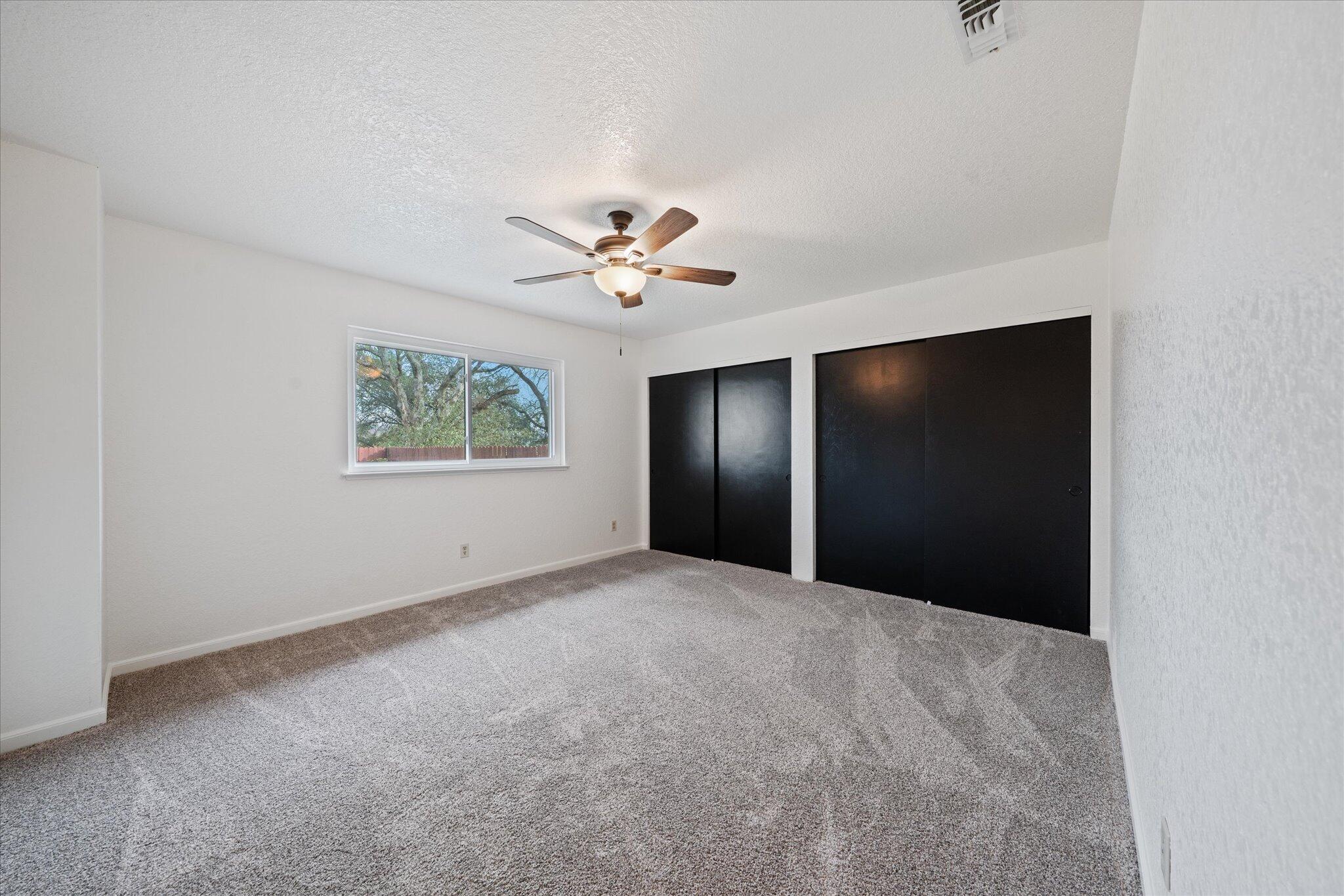 13770 Lisa Way Red Bluff, CA 96080 - Photo 19 of 43 an empty room with windows and fan