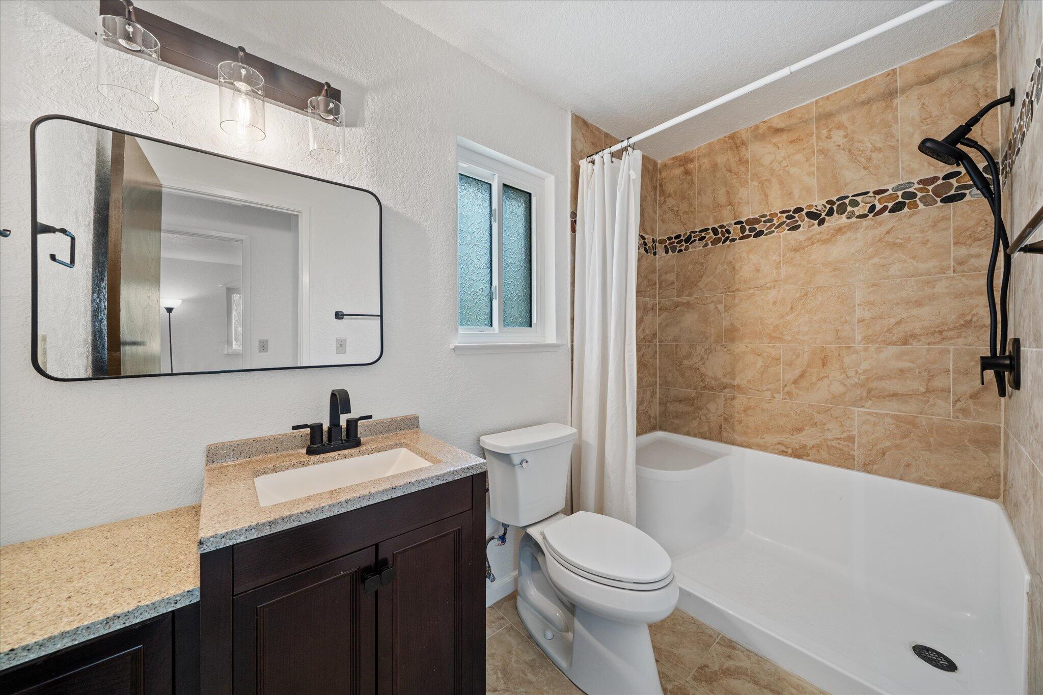 13770 Lisa Way Red Bluff, CA 96080 - Photo 24 of 43 a bathroom with a sink a toilet and shower