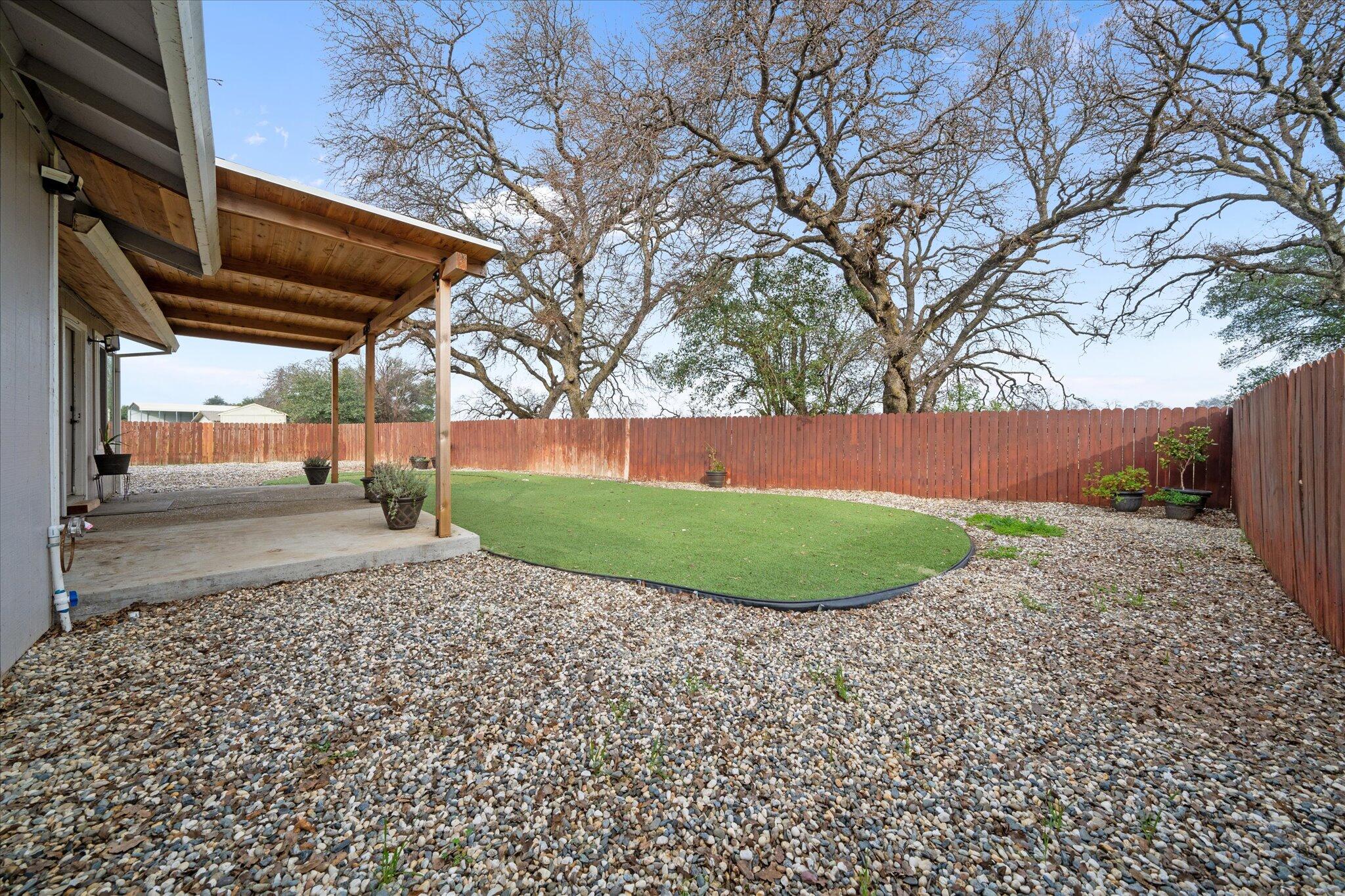 13770 Lisa Way Red Bluff, CA 96080 - Photo 30 of 43 a view of a backyard with large trees