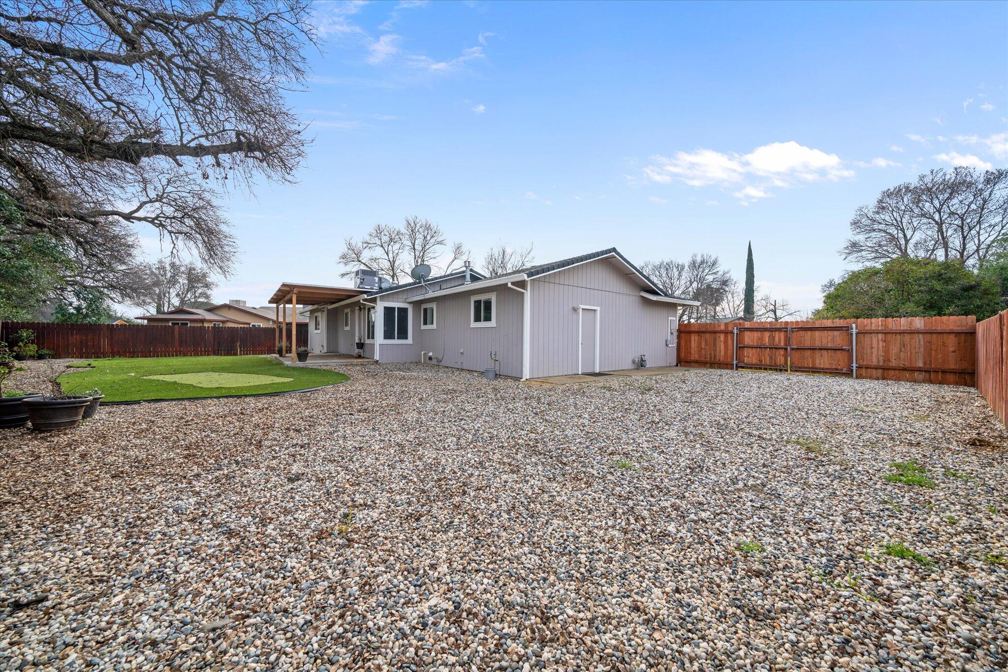 13770 Lisa Way Red Bluff, CA 96080 - Photo 34 of 43 a view of a house with backyard and trees