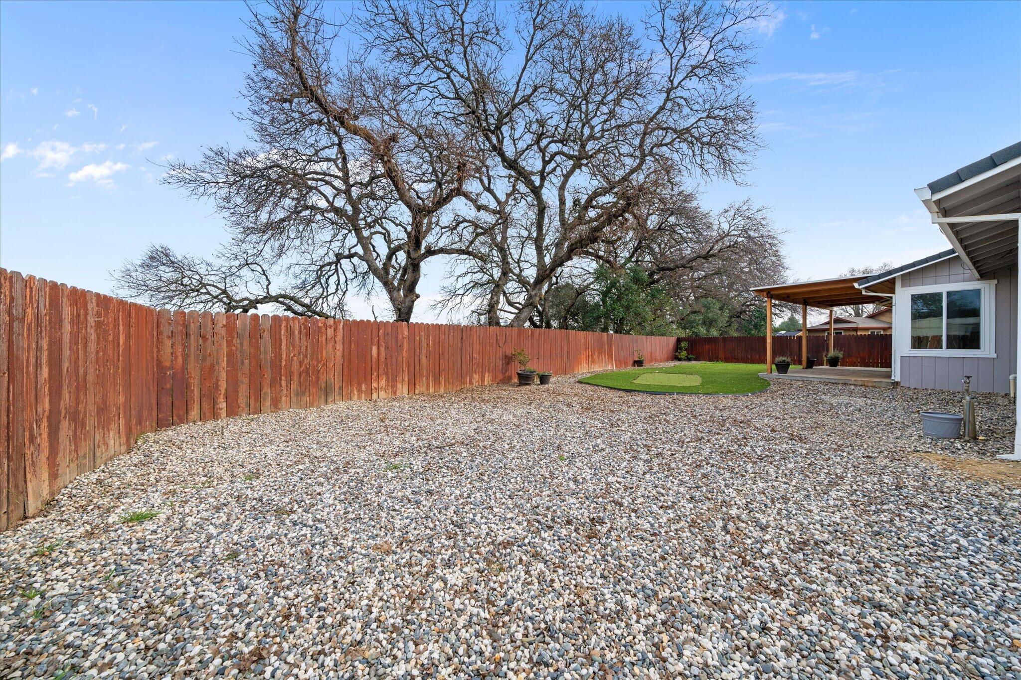 13770 Lisa Way Red Bluff, CA 96080 - Photo 35 of 43 a backyard of a house with wooden fence